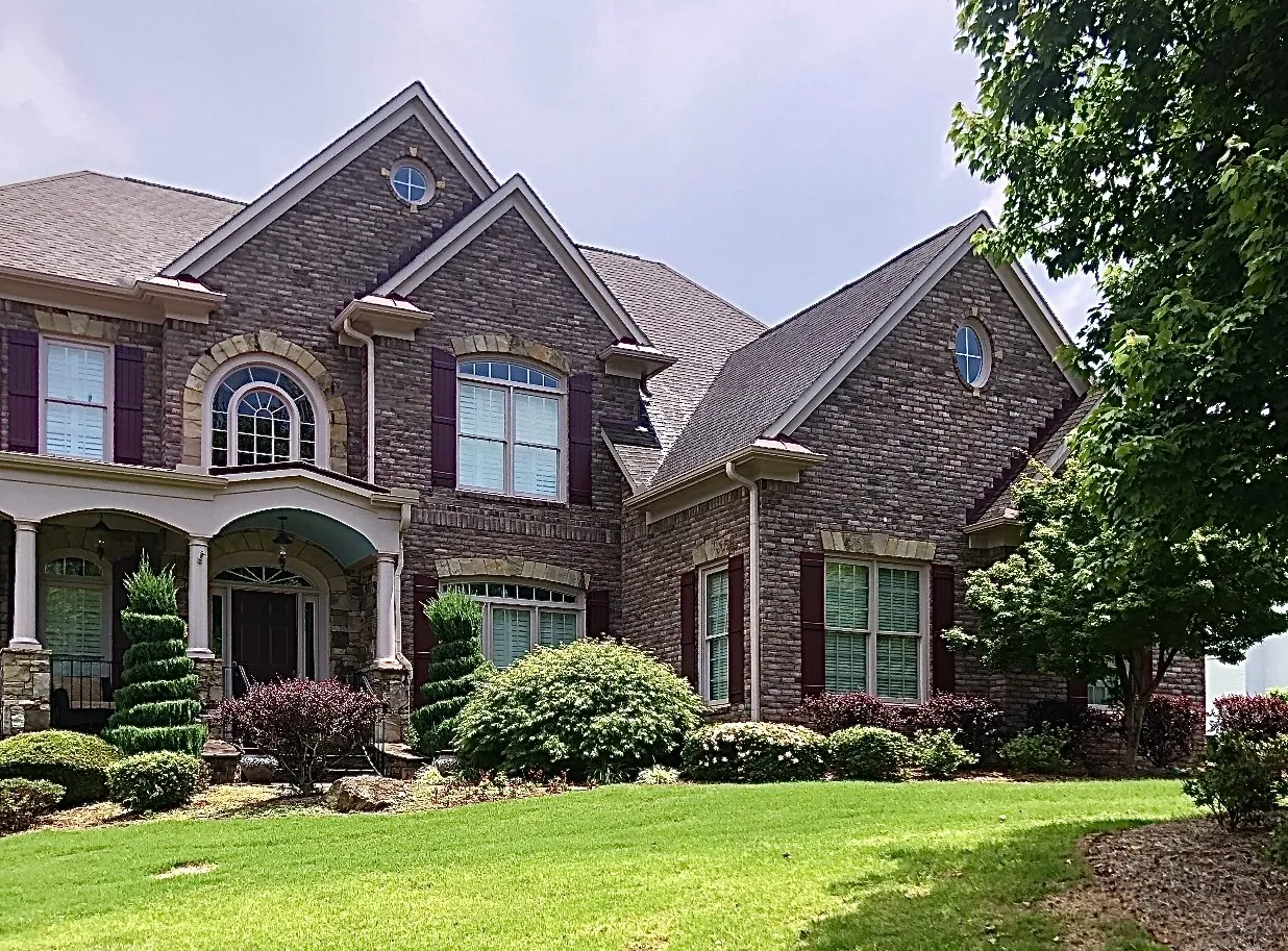 Burgundy composite board and batten shutters, front of a brick home – American Shutter Company, serving Alpharetta, GA 30009