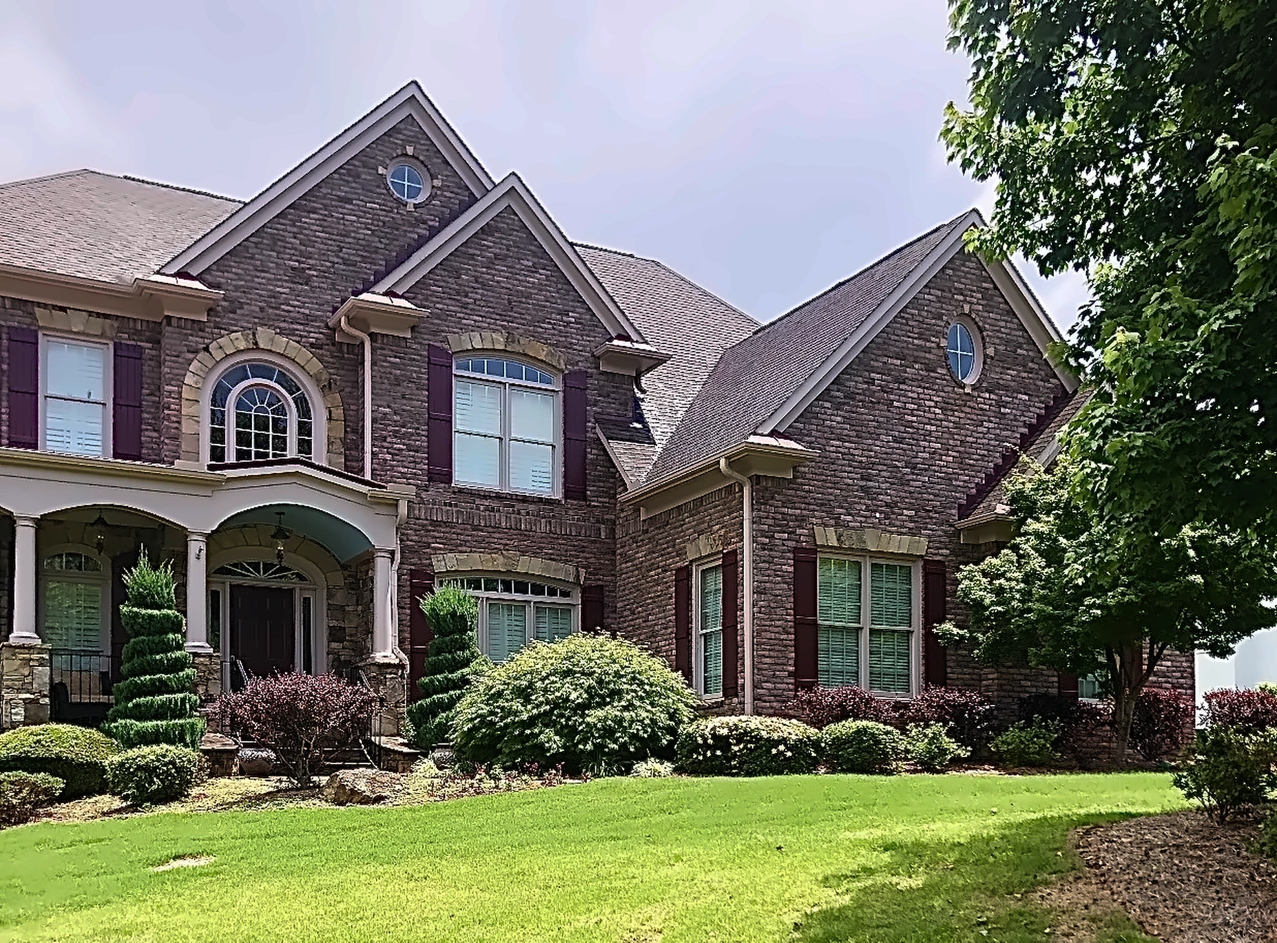Burgundy composite board and batten shutters, front of a brick home – American Shutter Company, serving Alpharetta, GA 30009